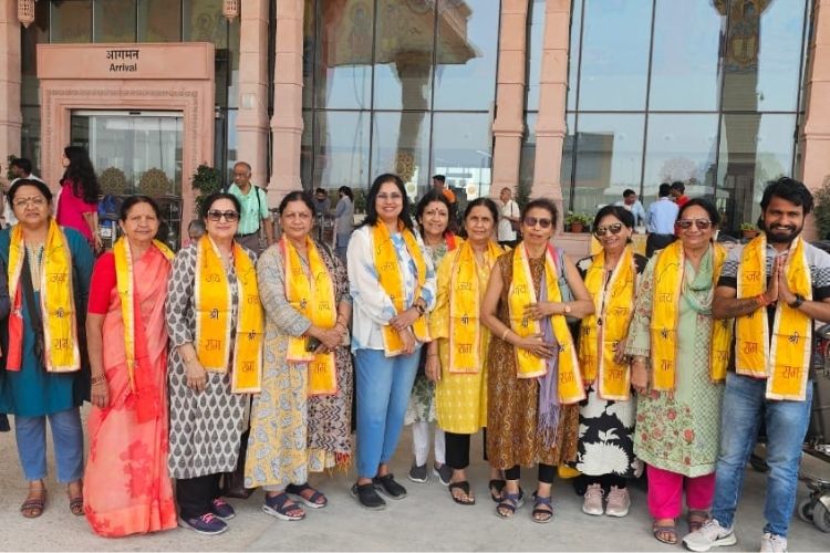 Travellers interacting with a team member from MP VACATION INDORE during a tour
