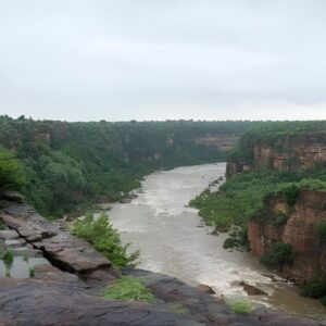 Rewa Madhya Pradesh waterfall surrounded by forested plateau and monsoon landscape