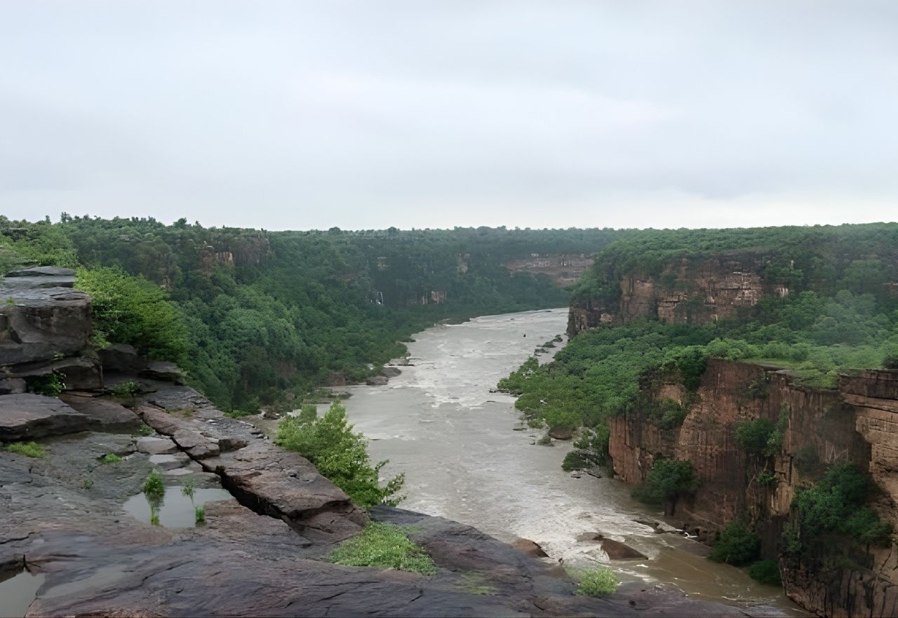 Rewa Madhya Pradesh waterfall surrounded by forested plateau and monsoon landscape